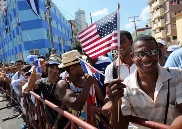 Hundred of Cubans gathered on the streets outside the newly reopened US embassy in Havana  to witness the historic raising of the Stars and Stripes. Picture: Getty