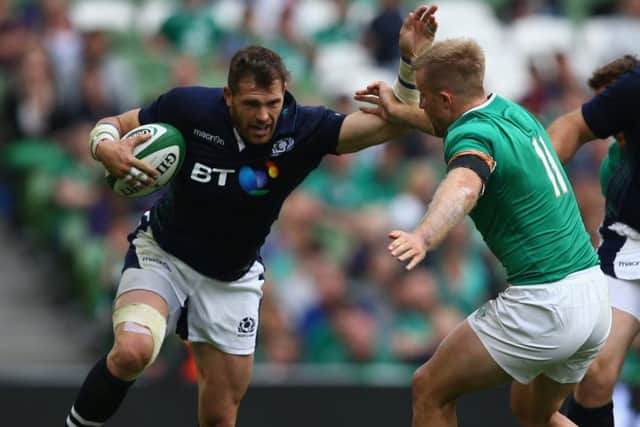 Sean Lamont holds off a tackle by Ireland's Luke Fitzgerald. Picture: Getty