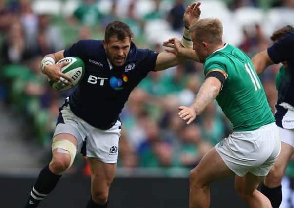 Sean Lamont holds off a tackle by Ireland's Luke Fitzgerald. Picture: Getty
