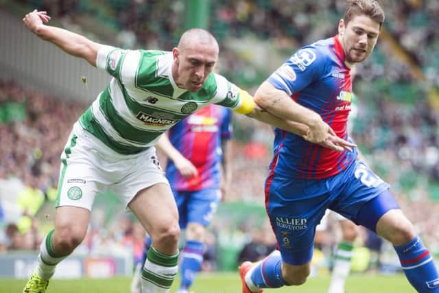 Celtic captain Scott Brown and Inverness Caley Thistle's Iain Vigurs vie for the ball. Picture: PA