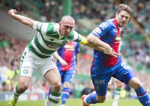 Celtic captain Scott Brown and Inverness Caley Thistle's Iain Vigurs vie for the ball. Picture: PA