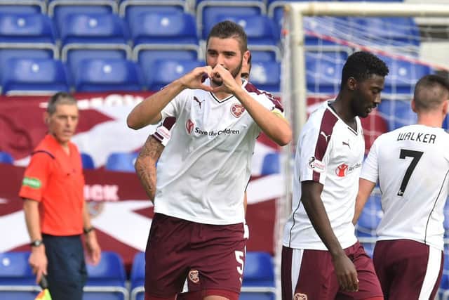 Hearts captain Alim Ozturk celebrates scoring his side's second goal, which proved decisive in their 2-1 victory over Ross County in Dingwall on Saturday. Picture: SNS