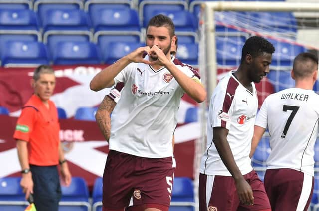 Hearts captain Alim Ozturk celebrates scoring his side's second goal, which proved decisive in their 2-1 victory over Ross County in Dingwall on Saturday. Picture: SNS