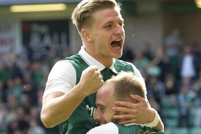 Jason Cummings celebrates with Hibs captain David Gray after scoring within seconds of entering the fray. Picture: Ian Rutherford