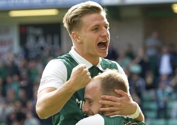 Jason Cummings celebrates with Hibs captain David Gray after scoring within seconds of entering the fray. Picture: Ian Rutherford