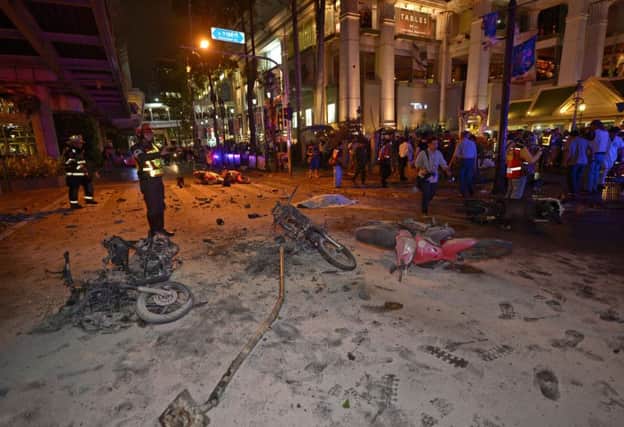 Thai soldiers inspect the scene after a bomb exploded outside a religious shrine in central Bangkok. Picture: Getty