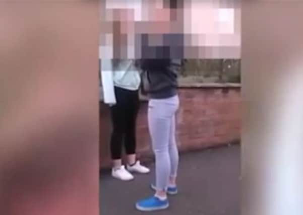 Police are investigating footage that shows a teenage girl bullying and tormenting another girl. Picture: YouTube
