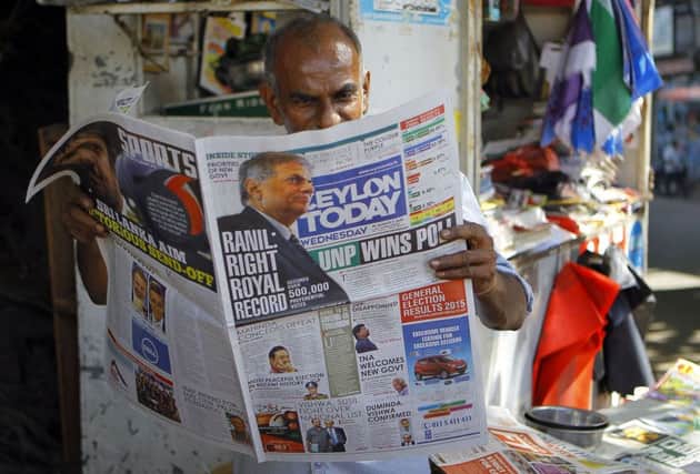 A Sri Lankan man reads a newspaper carrying news of Wickremesinghe's victory. Picture: AP
