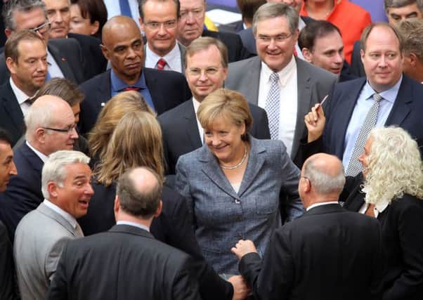 German Chancellor Angela Merkel casts her vote on a third bailout package for economically-troubled Greece. Picture: Getty