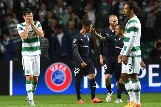 Celtics Nir Bitton, left, and Virgil van Dijk are dejected as Jo Inge Berget and his Malmo teammates celebrate the late goal. Picture: SNS
