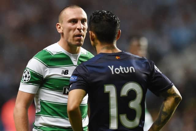 Celtic's Scott Brown exchanges words with Malmo's Yoshimar Yotun. Picture: SNS