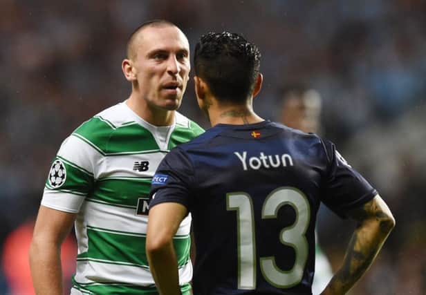 Celtic's Scott Brown exchanges words with Malmo's Yoshimar Yotun. Picture: SNS