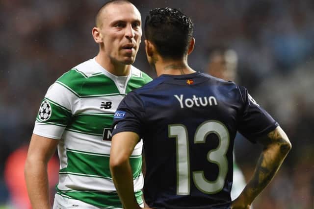 Celtic captain Scott Brown exchanges words with Malmö's Yoshimar Yotun during Wednesday's playoff tie at Celtic Park. Picture: SNS