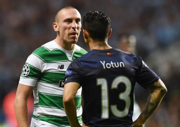 Celtic captain Scott Brown exchanges words with Malmö's Yoshimar Yotun during Wednesday's playoff tie at Celtic Park. Picture: SNS