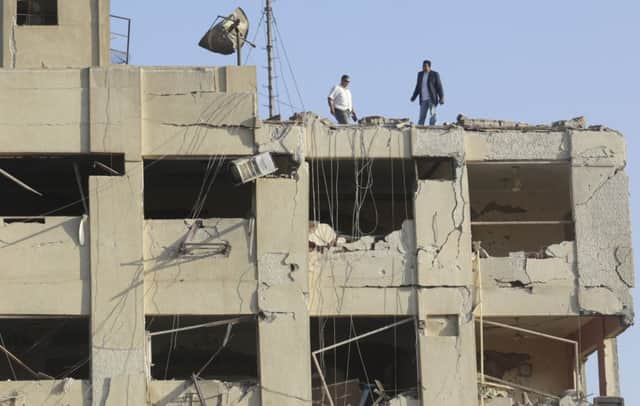 The wrecked frontage of surrounding buildings bore witness to the force of the blast which injured 29 people but caused no loss of life. Picture: AP