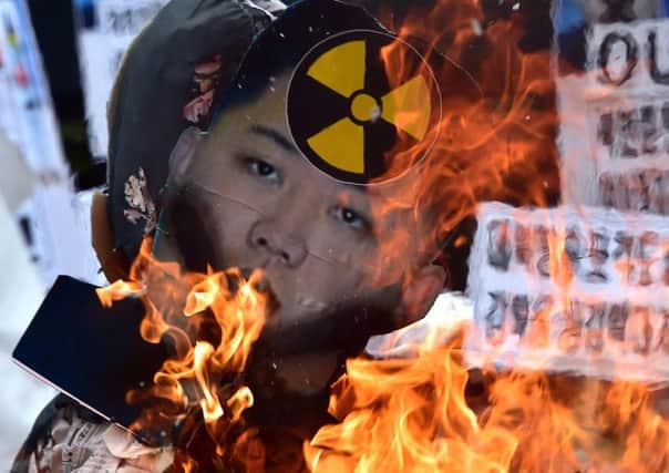 Activists in Seoul burn an effigy of Kim Jong Un during a protest against the Norths rocket firing. Picture: Getty