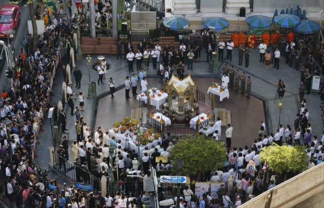 Thai officials and diplomats gather at the Erawan Shrine, the scene of Mondays bombing, in Bangkok. Picture: AP