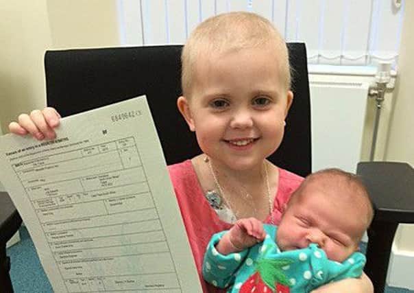 Agatha with newborn sister Meredith, whose life-saving blood will be stored for 25 years