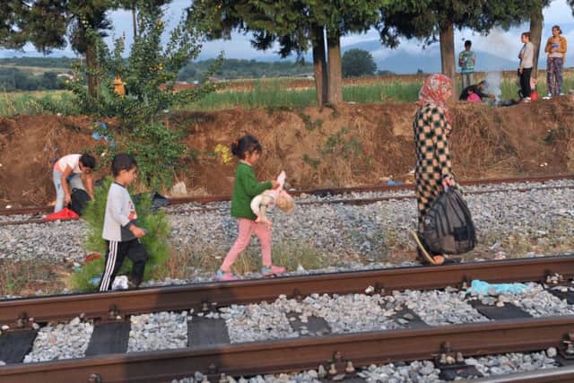 A family walks on a railway line near Gevgelija. Picture: AFP/Getty