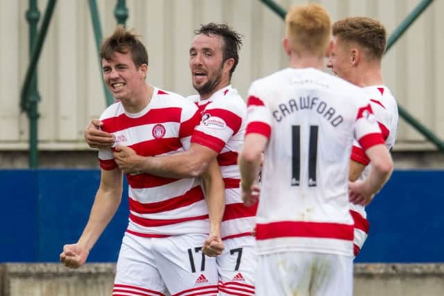 Louis Longridge (left) is congratulated by his team mates after scoring Hamilton's second goal of the game. Picture: SNS