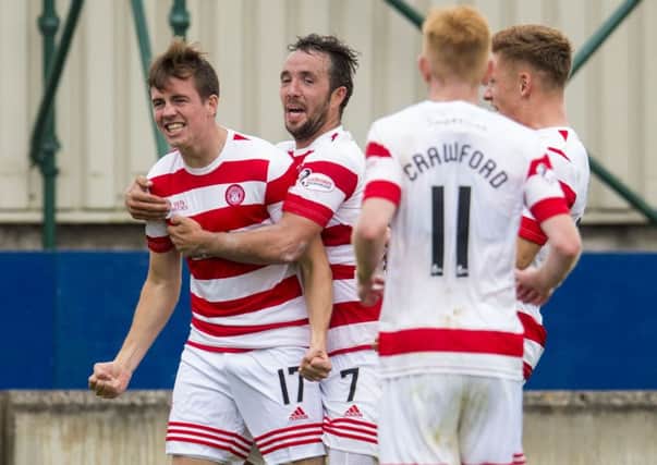 Louis Longridge (left) is congratulated by his team mates after scoring Hamilton's second goal of the game. Picture: SNS
