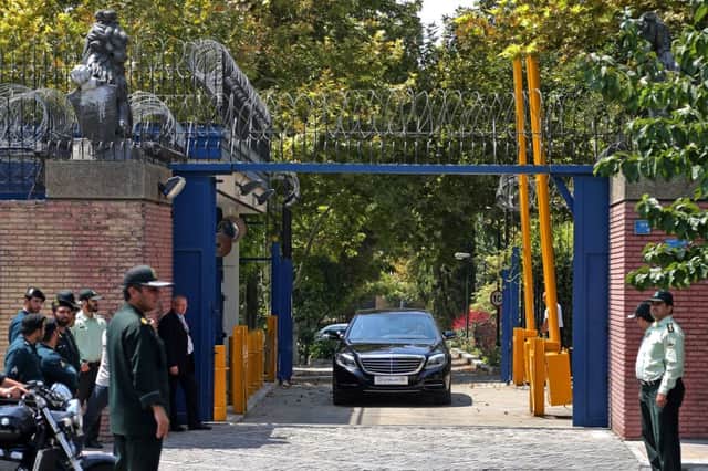 Escorted by Iranian police, a convoy carrying Philip Hammond leaves the embassy in Tehran. Picture: AP