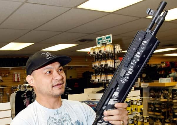 A buyer examines a weapon at a Las Vegas gun store. Picture: Getty
