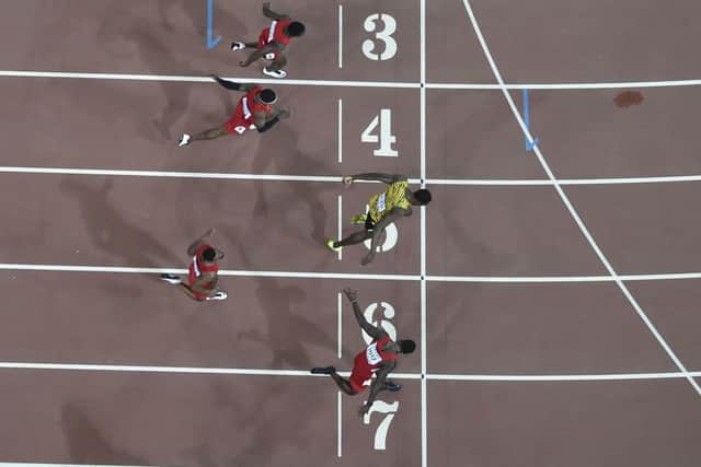 Bolts lunge earned him gold ahead of Justin Gatlin, who admitted he "got nipped at the line by the great Usain". Picture: AFP