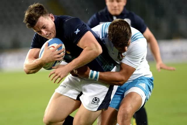 Scotlands Matt Scott, left, is tackled by Italys Tommaso Allan, in a largely scrappy and featureless game. Picture: AP