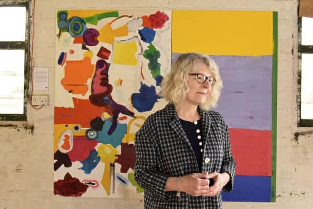 Rowena Comrie with her painting The Sun Never Sets?. Picture: Andy Thompson