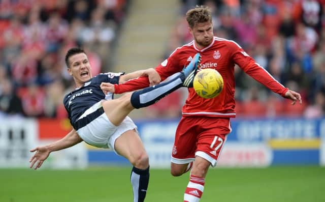 Dundees Thomas Konrad makes a desperate lunge in his bid to dispossess Aberdeens David Goodwillie. Picture: SNS