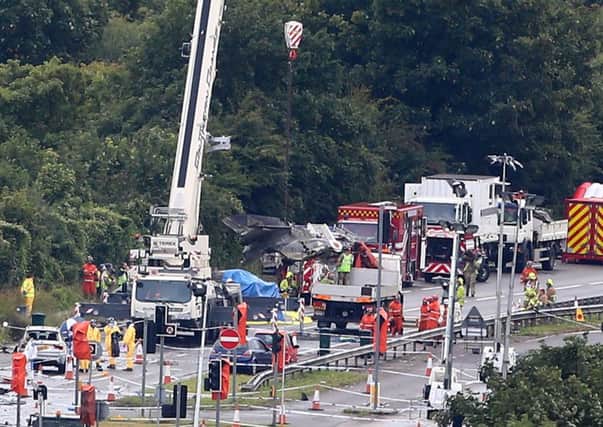 The damaged remains of the fuselage of a Hawker Hunter fighter jet are lifted by crane . Picture: Getty