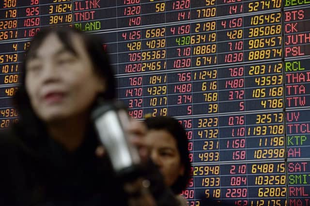 Investors in front of an electronic board showing stock movements. Picture: AFP/Getty