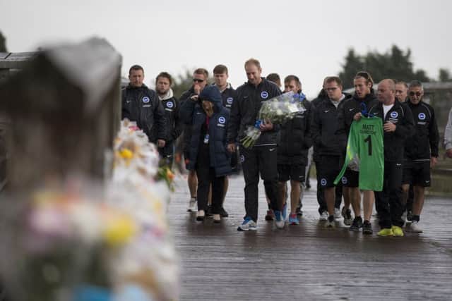 Football club ground staff arrive to pay their tributes. Picture: AP