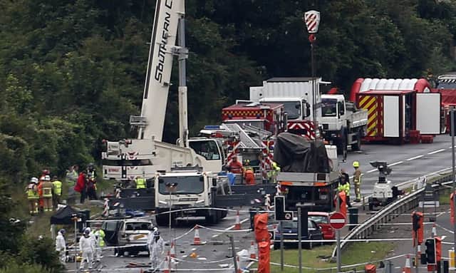 A giant crane is used to remove wreckage of the plane on the A27 at Shoreham in West Sussex. Picture: PA