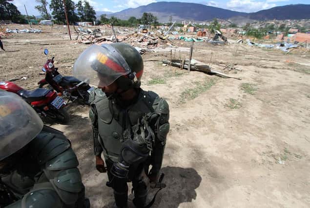 Venezuelan soldiers patrol among the rubble of houses of deported Colombians in the border city of San Antonio. Picture: AFP/Getty