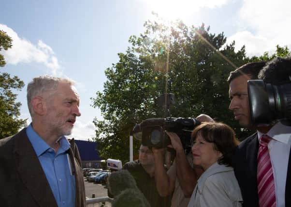 Labour leadership candidate Jeremy Corbyn (L) speaks to the media as he leaves a radio hustings. Picture: Getty