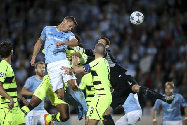 Malmo's Markus Rosenberg opens the scoring with a close range header. Picture: AP