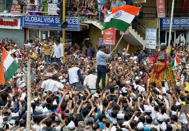 The arrest of Patidar leader Hardik Patel, holding flag, sparked further rioting across Gujarat, leading to a curfew. Picture: Getty