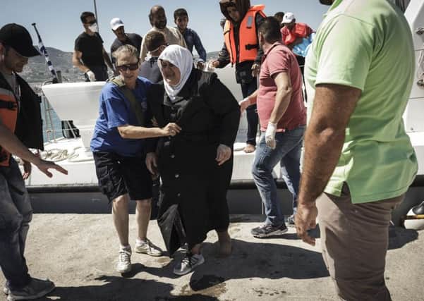 Migrants are helped off a boat in Greece.  Picture: Getty