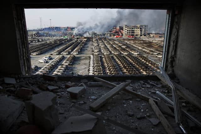 A shattered window frames the site of the explosion on 12 August at a factory handling dangerous chemicals. Picture: AP