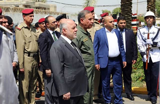 Haider al-Abadi, centre, at the funeral of one of the generals. Picture: AP