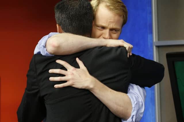 The shows anchor Chris Hurst, right, hugs Hirsbrunner. Picture: AP