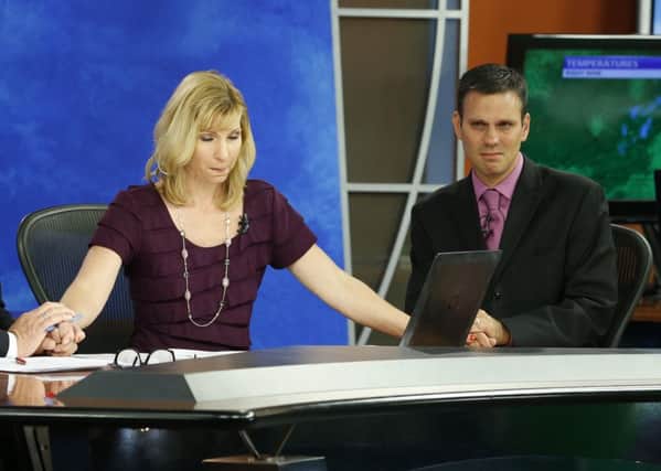 Kim McBroom joins hands with weatherman Leo Hirsbrunner. Picture: AP