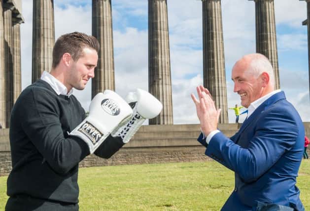 Barry McGuigan, right, and new signing Josh Taylor, enjoy a mock sparring session on Edinburghs Calton Hill. Picture: Ian Georgeson