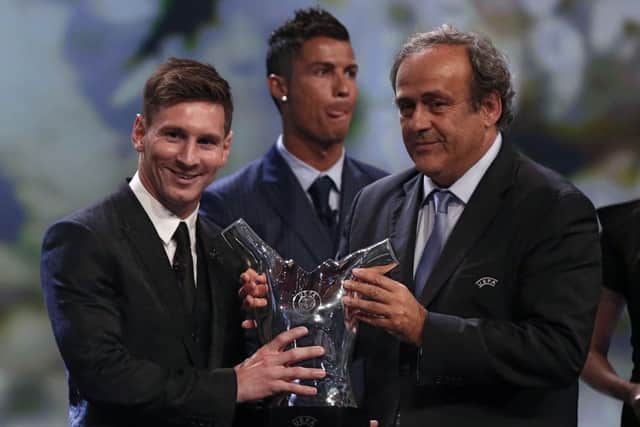 Uefa president Michel Platini, right, presents Barcelona forward Lionel Messi with the trophy for the Best Player in Europe. Picture: Getty