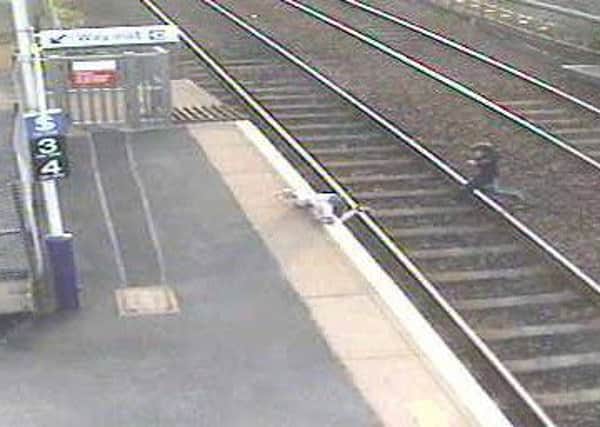 The boy was spotted running across the train tracks in this CCTV footage at Wester Hailes station. Picture: BTP