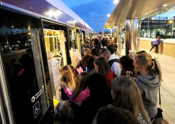 Concert goers attempt to board the tram at Murrayfield. Customers claim jam-packed services are common. Picture: Lisa Ferguson