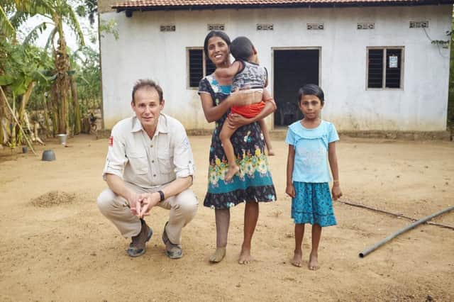 James Cowan with Sasikala, who has now built a permanent house for her family on cleared land in Kilinochchi, Sri Lanka. Picture: Devaka Seneviratne