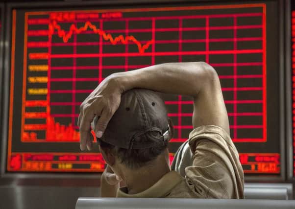 A Chinese day trader watches a stock ticker at a local brokerage house on August 27, 2015 in Beijing. Picture: Getty Images